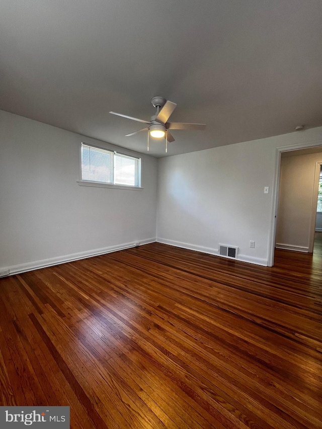 empty room with ceiling fan and hardwood / wood-style floors