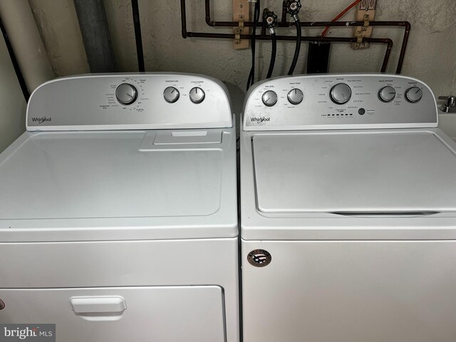 clothes washing area with washing machine and dryer