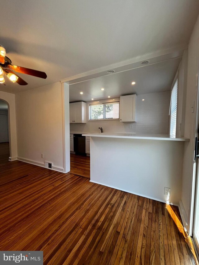 unfurnished living room with ceiling fan and hardwood / wood-style floors