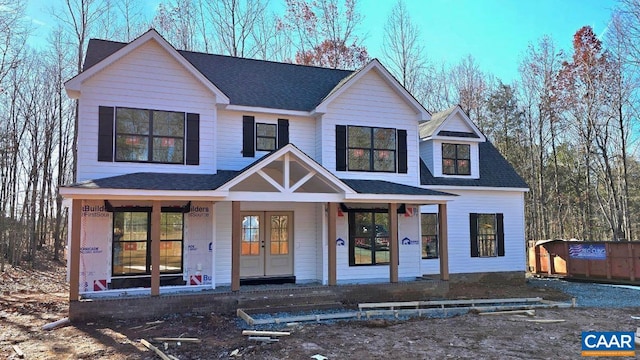 view of front of house with a porch and a shingled roof