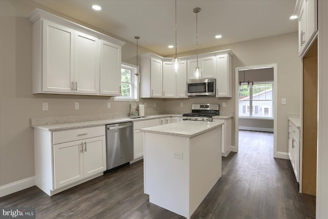 kitchen featuring a kitchen island, stainless steel appliances, and white cabinetry