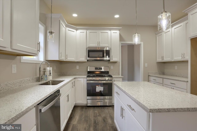 kitchen featuring stainless steel appliances, sink, dark hardwood / wood-style floors, and white cabinetry