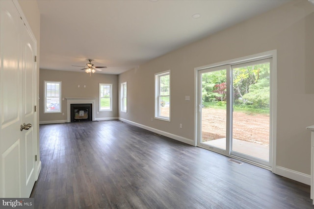 unfurnished living room with ceiling fan and dark hardwood / wood-style floors