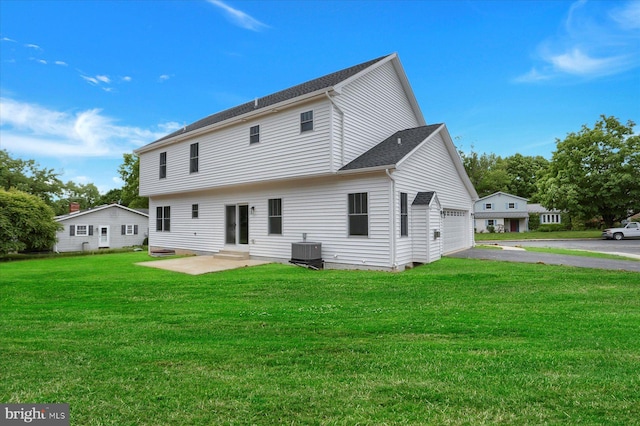 back of property featuring central AC unit and a lawn