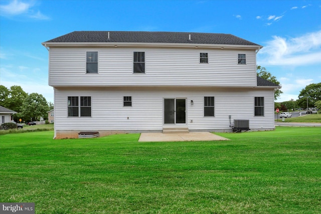 rear view of house featuring a yard, a patio area, and central AC