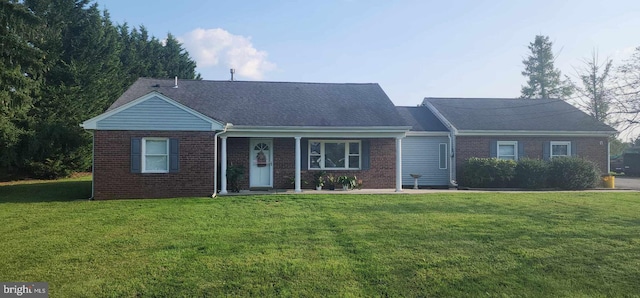 ranch-style house with brick siding and a front yard