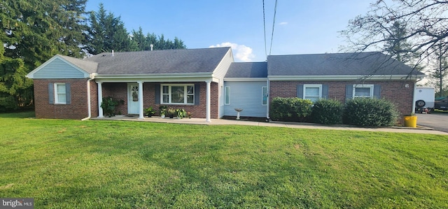 ranch-style home with a front lawn and brick siding