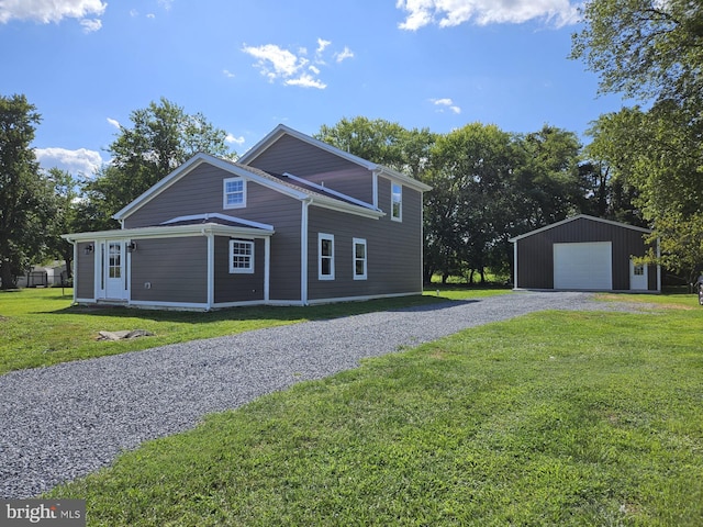 view of front of property with an outdoor structure, a garage, and a front yard