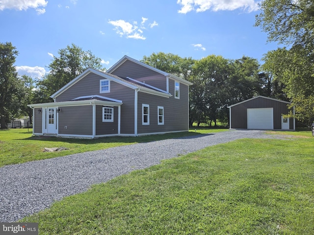 view of property exterior featuring gravel driveway, a yard, a detached garage, and an outbuilding