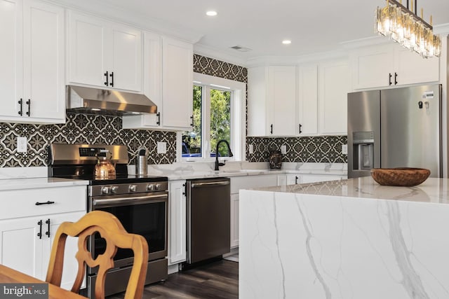 kitchen featuring crown molding, decorative light fixtures, stainless steel appliances, dark hardwood / wood-style flooring, and white cabinets