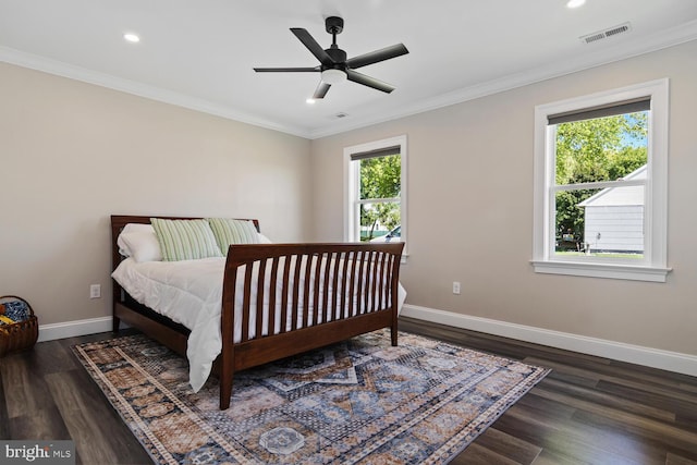 bedroom featuring dark wood-type flooring, ceiling fan, and ornamental molding