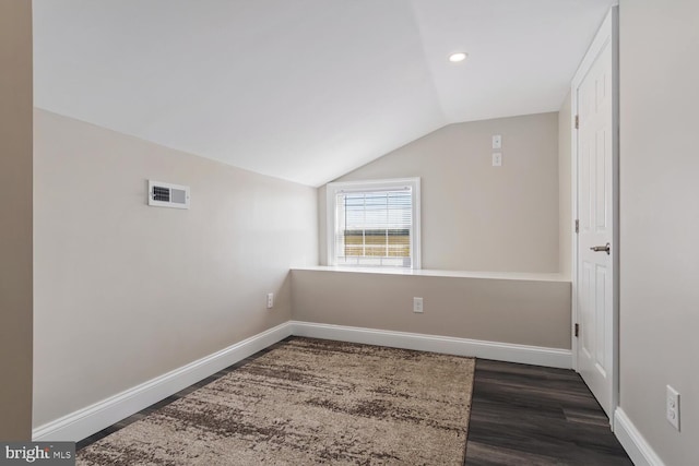 bonus room with lofted ceiling, visible vents, dark wood finished floors, and baseboards