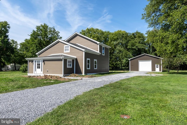 view of front of property featuring an outbuilding, a front yard, a garage, and gravel driveway