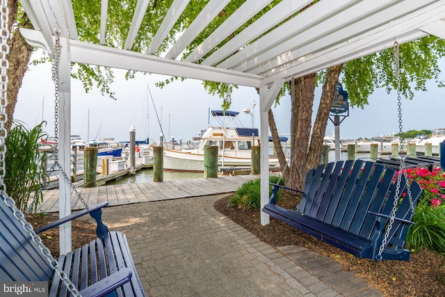 view of patio / terrace with a dock, a water view, and a pergola