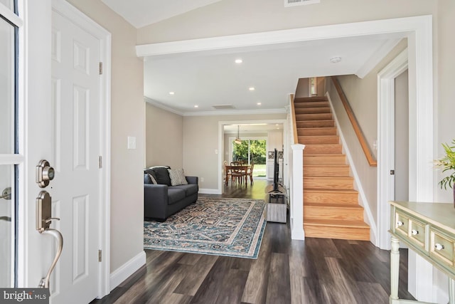 entryway with dark wood-style floors, crown molding, recessed lighting, baseboards, and stairs