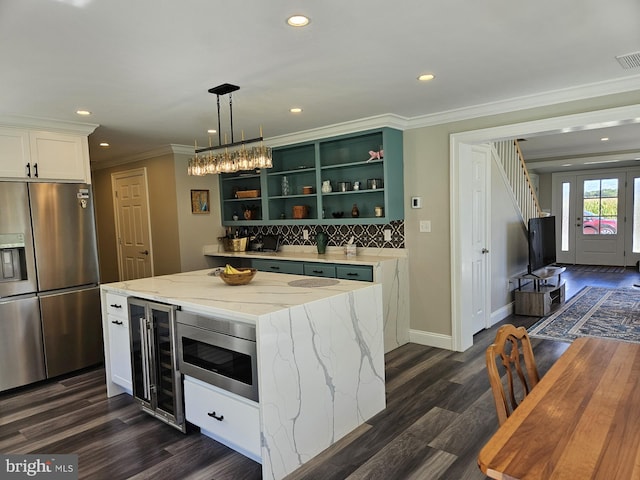 kitchen featuring white cabinetry, wine cooler, dark hardwood / wood-style flooring, a kitchen island, and appliances with stainless steel finishes