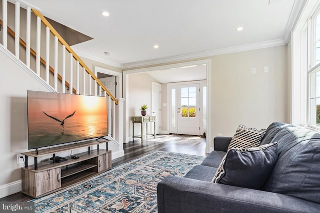 living room featuring ornamental molding, dark wood finished floors, stairway, and baseboards