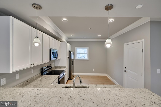 kitchen featuring white cabinets, appliances with stainless steel finishes, hanging light fixtures, and light stone countertops