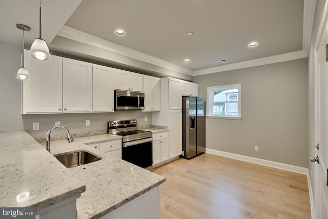 kitchen with light stone counters, white cabinets, hanging light fixtures, sink, and appliances with stainless steel finishes