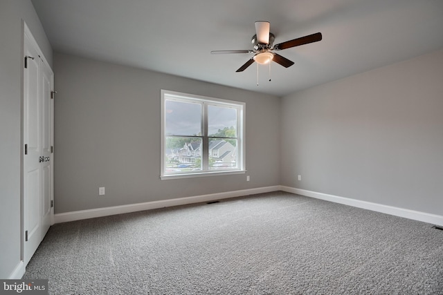 carpeted spare room featuring ceiling fan