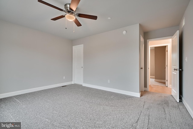 unfurnished bedroom featuring light carpet and ceiling fan