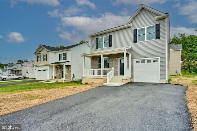 front facade featuring a porch and a garage