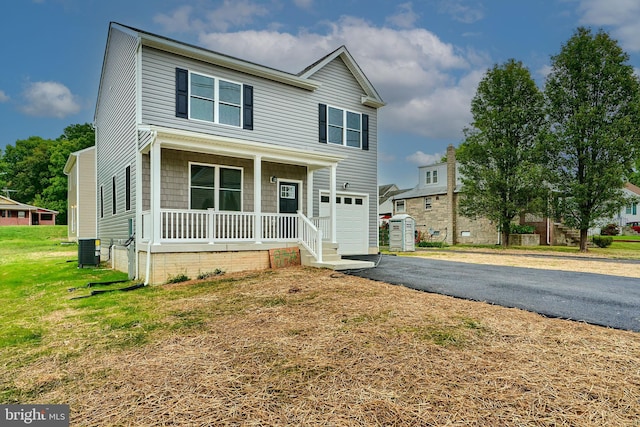 view of front of property featuring a front lawn, cooling unit, and covered porch