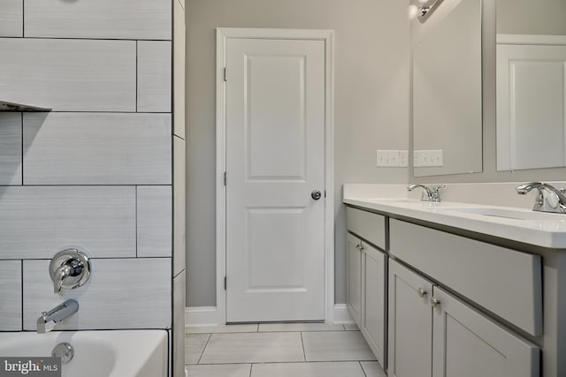 bathroom with tile patterned flooring, vanity, and bathtub / shower combination