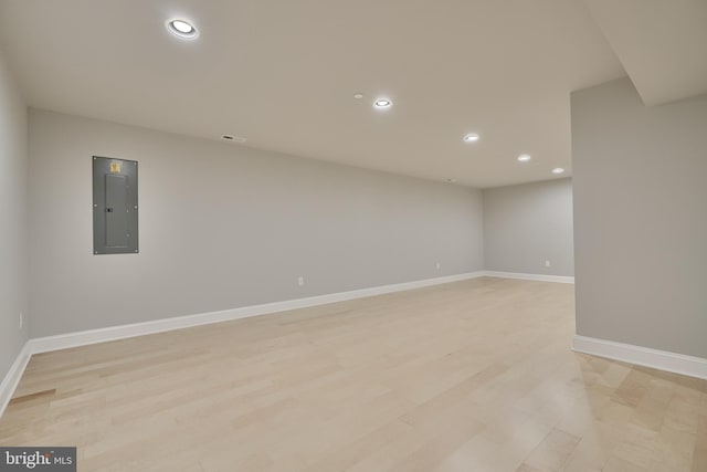 spare room with light hardwood / wood-style flooring and electric panel