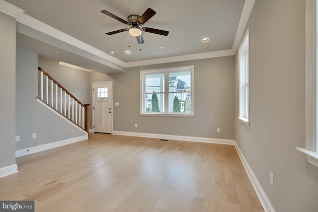 foyer entrance featuring ornamental molding, ceiling fan, and light hardwood / wood-style flooring