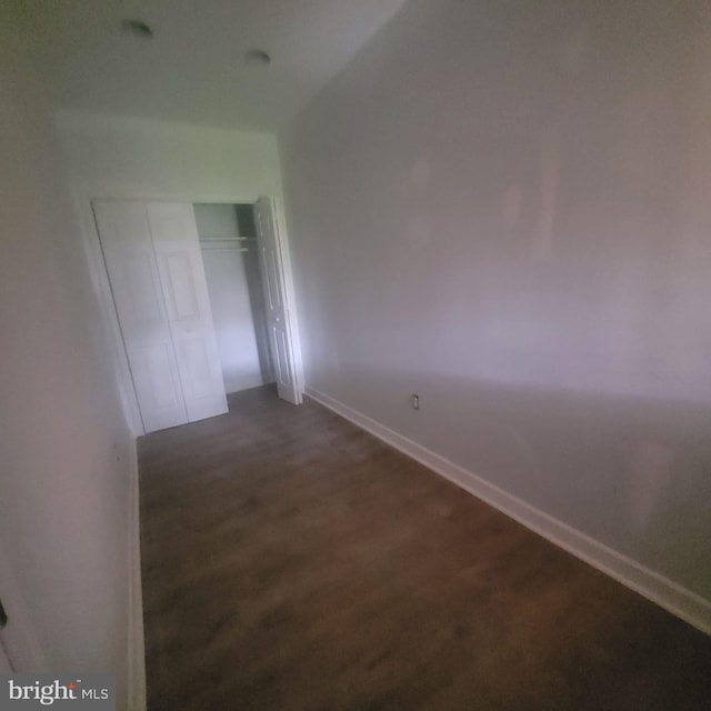 spare room with dark colored carpet