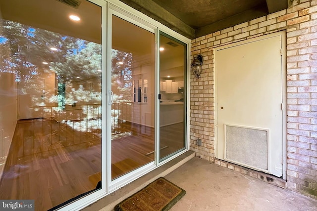 entrance to property with brick siding