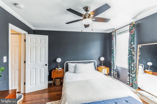 bedroom featuring a ceiling fan, dark wood finished floors, and crown molding