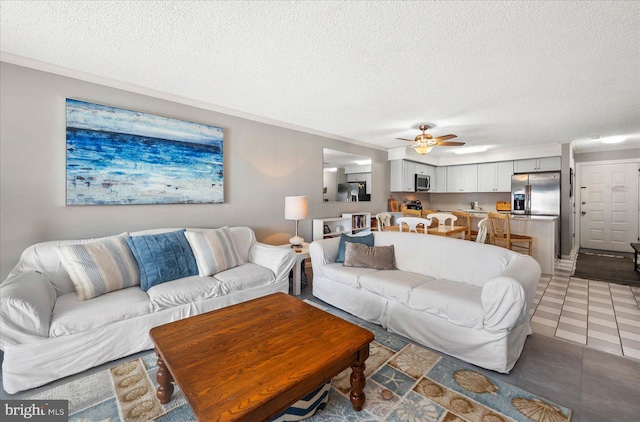 living room featuring tile patterned floors, a textured ceiling, and ceiling fan