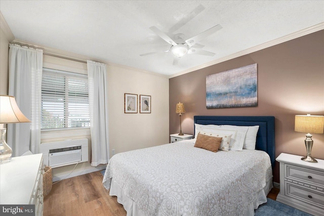 bedroom with light wood-style floors, ceiling fan, ornamental molding, and an AC wall unit