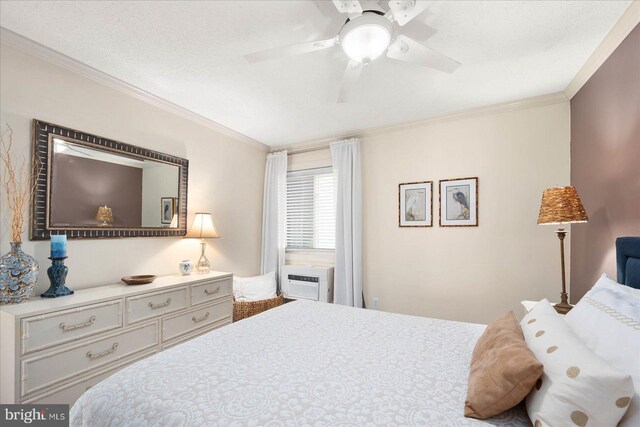 bedroom with ceiling fan, an AC wall unit, and ornamental molding