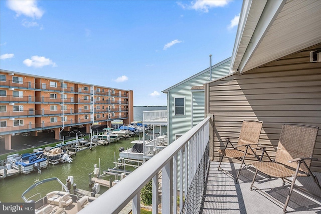 balcony featuring a boat dock and a water view