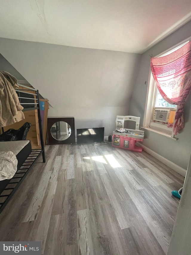 bonus room featuring cooling unit and hardwood / wood-style floors