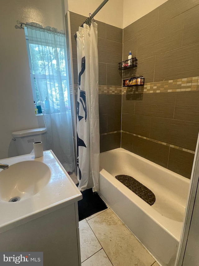 bathroom featuring vanity, shower / tub combo with curtain, and tile patterned floors