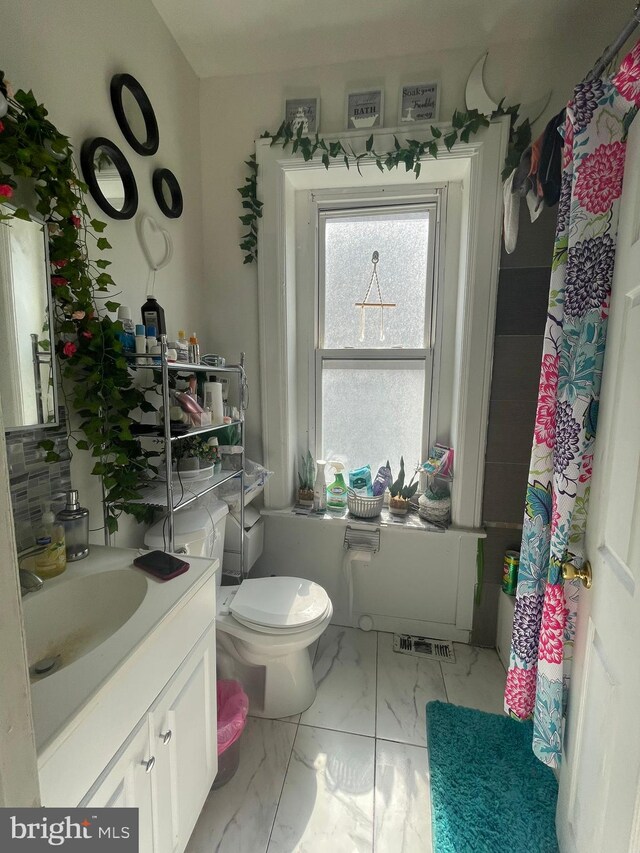 bathroom featuring vanity, toilet, curtained shower, and tile patterned flooring