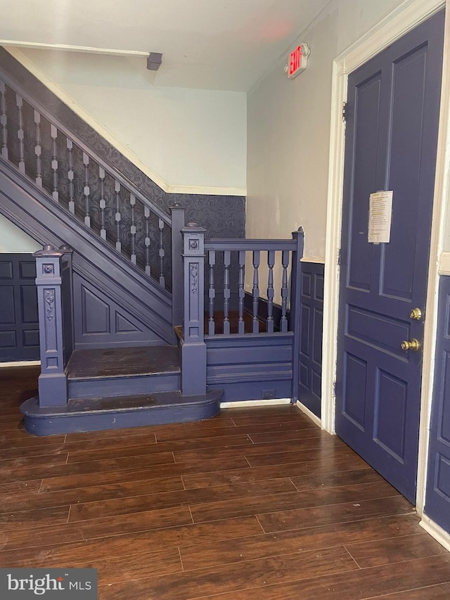 stairs featuring hardwood / wood-style floors