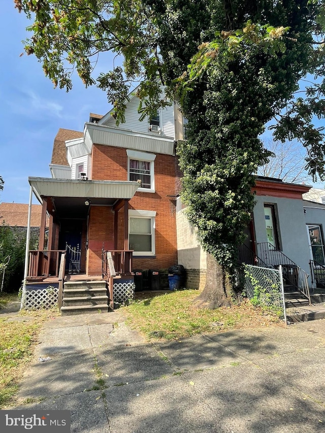 view of front facade featuring covered porch and brick siding