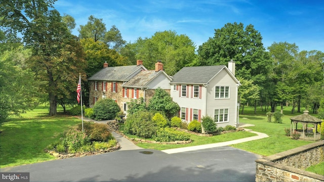 view of front of house featuring a gazebo and a front yard