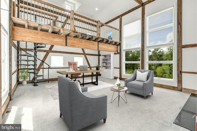 living area featuring stairs, light carpet, a towering ceiling, and baseboards