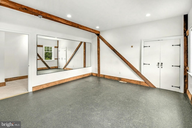 interior space with recessed lighting, beam ceiling, and baseboards