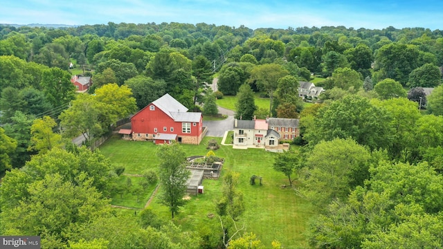 birds eye view of property with a view of trees