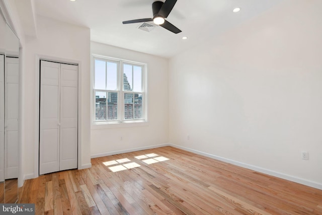 unfurnished bedroom with light wood-type flooring and ceiling fan