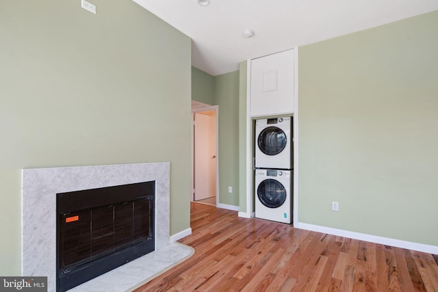 interior space with light hardwood / wood-style floors and stacked washer and clothes dryer