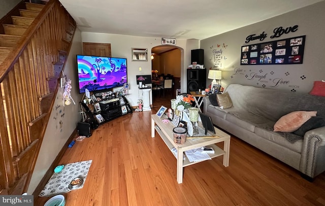 living room featuring wood walls and wood-type flooring