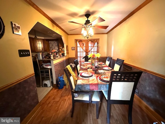 dining room featuring ceiling fan, hardwood / wood-style flooring, ornamental molding, and french doors